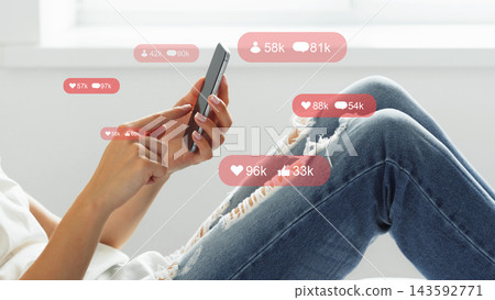 Social media chats and calls taking place on a smartphone in a casual indoor setting during daytime Social media chats and calls taking place on a smartphone in a casual indoor setting during daytime 143592771