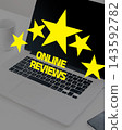 Online reviews and star ratings displayed on a laptop screen 143592782