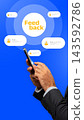 Hand holding a smartphone with feedback icons on a blue background during a feedback session 143592786