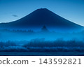 The trees and Mount Fuji in the blue hour, shrouded in morning mist. 143592821