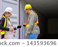 Pregnant female logistics supervisor using digital tablet with warehouse loading worker man at cargo shipping container yard 143593696