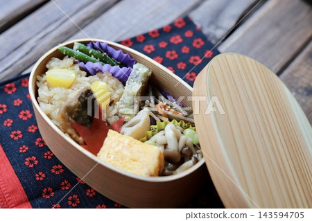 Autumn Japanese food bento box with sticky rice, served in a bentwood box. Autumn Japanese food bento box with sticky rice, served in a bentwood box. 143594705