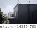 The residential area was dimly lit even in the middle of the day due to the heavy autumn rain. 143594763