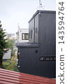 The residential area was dimly lit even in the middle of the day due to the heavy autumn rain. 143594764