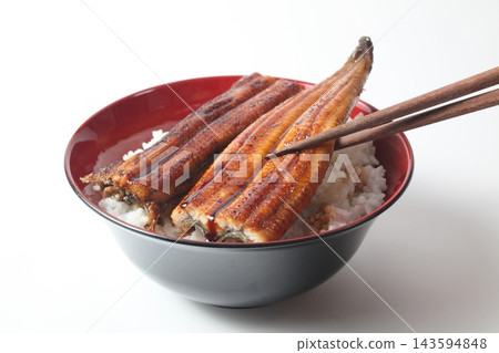 Unadon (eel rice bowl) where the eel is lifted with chopsticks. Unadon (eel rice bowl) where the eel is lifted with chopsticks. 143594848