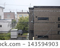 The residential area was dimly lit even in the middle of the day due to the heavy autumn rain. 143594903