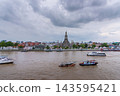 Bangkok, Thailand - June 11, 2025: Evening view of tourists watching the sunset along the Chao Phraya River at Wat Arun. 143595421