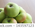 Green apples on a sieve 143597123