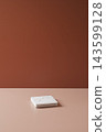Minimalist brown background with a warm terracotta wall and beige surface, creating a clean and elegant backdrop for product photography. 143599128