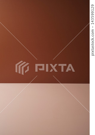 Minimalist brown background with a warm terracotta wall and beige surface, creating a clean and elegant backdrop for product photography. Minimalist brown background with a warm terracotta wall and beige surface, creating a clean and elegant backdrop for product photography. 143599129