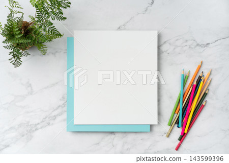 Top view of blank white and blue square greeting card with pencil mockup on marble background with copy space Top view of blank white and blue square greeting card with pencil mockup on marble background with copy space 143599396