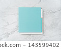 Top view of blank white and blue square greeting card with pencil mockup on marble background with copy space 143599402