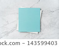 Top view of blank blue and white square greeting card mockup on marble background with copy space 143599403