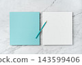 Top view of blank blue and white square greeting card with color pencil mockup on marble background with copy space 143599406