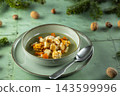 Vegetable soup with croutons and nuts on green background 143599996