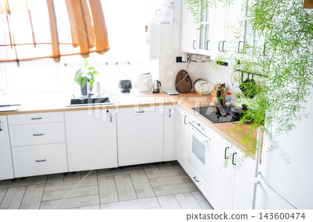 Top view look down at a sleek white scandinavian kitchen corner layout with wooden surfaces, home design, cozy lifestyle. 143600474
