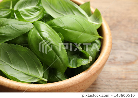 Fresh basil leaves on wooden table, closeup 143600510