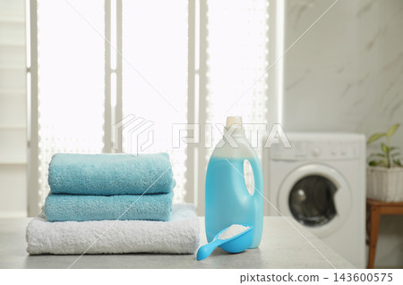 Clean towels and detergents on table in laundry room Clean towels and detergents on table in laundry room 143600575