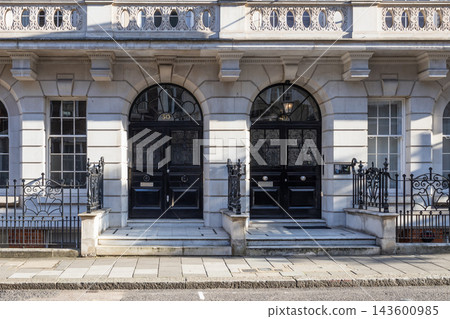 Traditional townhouse facade with twin arched front doors Traditional townhouse facade with twin arched front doors 143600985