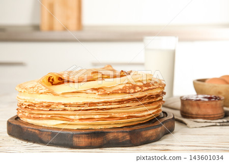 Fresh thin pancakes on white wooden table Fresh thin pancakes on white wooden table 143601034