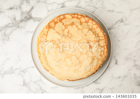 Stack of fresh thin pancakes on white marble table, top view Stack of fresh thin pancakes on white marble table, top view 143601035