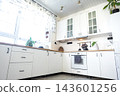 Wide angle shot of a clean minimal white kitchen interior with wooden countertops and glass cabinets, home design, cozy lifestyle. 143601256