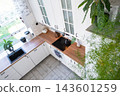 High perspective look down at a white scandinavian kitchen corner with green plants and black sink, home design, cozy lifestyle. 143601259