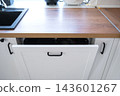 Close up of a modern white kitchen drawer under a wooden countertop, furniture assembly, kitchen installation. 143601267