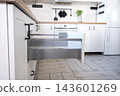 Wide view of opened white wooden kitchen drawers showing modern metallic runner mechanism, furniture assembly, kitchen installation. 143601269