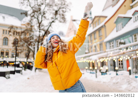 A young tourist enjoys a sunny winter day. The concept of holiday, relaxation. A young tourist enjoys a sunny winter day. The concept of holiday, relaxation. 143602012