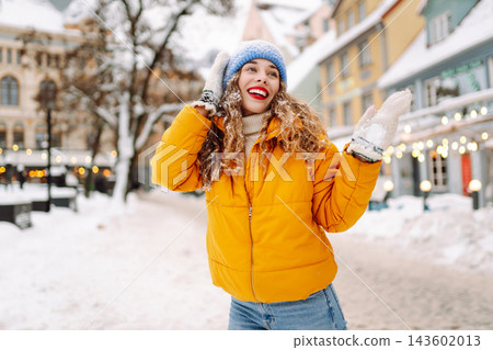 A young tourist enjoys a sunny winter day. The concept of holiday, relaxation. A young tourist enjoys a sunny winter day. The concept of holiday, relaxation. 143602013