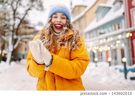 A young tourist enjoys a sunny winter day. The concept of holiday, relaxation. A young tourist enjoys a sunny winter day. The concept of holiday, relaxation. 143602018
