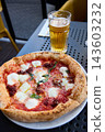 Delicious Neapolitan Pizza and Cold Beer on a Sunny Outdoor Terrace Table 143603232