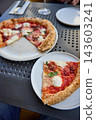 Delicious Neapolitan Pizza Served on a Terrace Table in an Outdoor Cafe 143603241