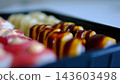 Delicious sushi delivery in black containers with assorted fresh rolls on white background 143603498