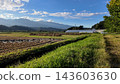 A rural landscape of Nakagawa Village, Watari, with rice paddies and mountains stretching out before you - Nakagawa Village, Kamiina District, Nagano Prefecture, Japan 143603630