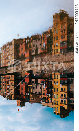 Upside down reflection of colorful Girona buildings in Onyar river Spain. Creative urban composition for travel editorials abstract backgrounds and tourism design projects Upside down reflection of colorful Girona buildings in Onyar river Spain. Creative urban composition for travel editorials abstract backgrounds and tourism design projects 143603948