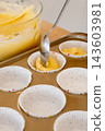 Cupcake cooking. Treat baking. Spoon placing sweet dough in empty paper liners. Making portion tasty home dessert process background. 143603981