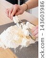 Confectioner work. Cake recipe. Woman hand grinding cutting butter pieces with wheat flour making tasty baking ingredients with knife. 143603986