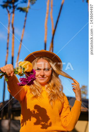 Woman faceless yellow sweater showing into camera Autumn Fall Bouquet for Thanksgiving holiday. Seasonal Warm colorful blossom flowers arrangement festive decoration Woman faceless yellow sweater showing into camera Autumn Fall Bouquet for Thanksgiving holiday. Seasonal Warm colorful blossom flowers arrangement festive decoration 143604497
