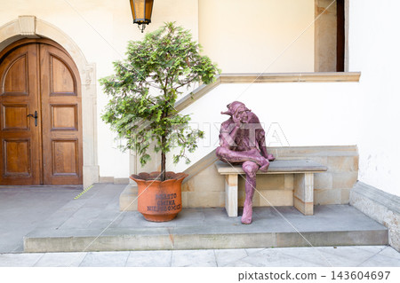 Cozy Mediterranean patio with a stone bench and decorative statue Cozy Mediterranean patio with a stone bench and decorative statue 143604697