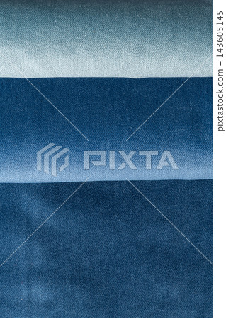 Shades of blue folded denim fabric texture concept Shades of blue folded denim fabric texture concept 143605145
