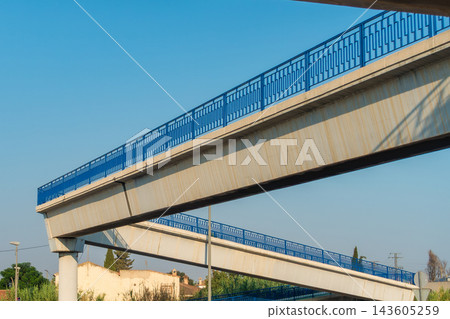 Long Fenced Pedestrian Ramp Bridge Over Highway Long Fenced Pedestrian Ramp Bridge Over Highway 143605259