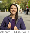 Successful young woman smiling in park for profile avatar photo 143605433