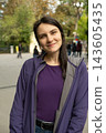 Real smiling woman 30s no makeup outdoors portrait 143605435
