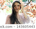 Close up headshot of happy woman laughing naturally without makeup outdoors 143605443