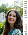 Close up headshot of beautiful middle aged brunette woman looking at camera 143605451