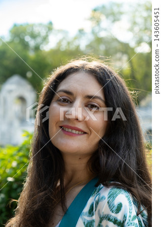 Close up headshot of beautiful middle aged brunette woman looking at camera Close up headshot of beautiful middle aged brunette woman looking at camera 143605451