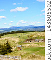 A breathtaking view of vast pastures and majestic mountain ranges from an observation deck in Kushiro, Hokkaido. 143605502