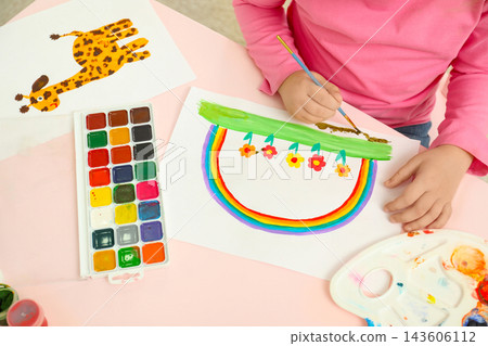 Little child painting at pink table, closeup 143606112
